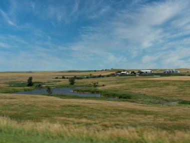Güney Dakota, ABD 'de 44. Otoyol boyunca uzanan küçük bir göletin yol kenarı manzarası.