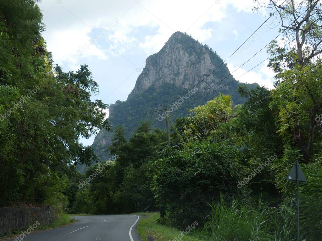 Winding road with one of the Piton mountains in the backdrop, a popular landmark in St Lucia.