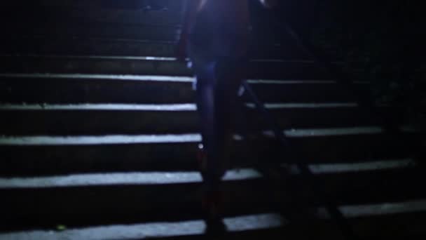 Girl climbing steps at night — Stock Video