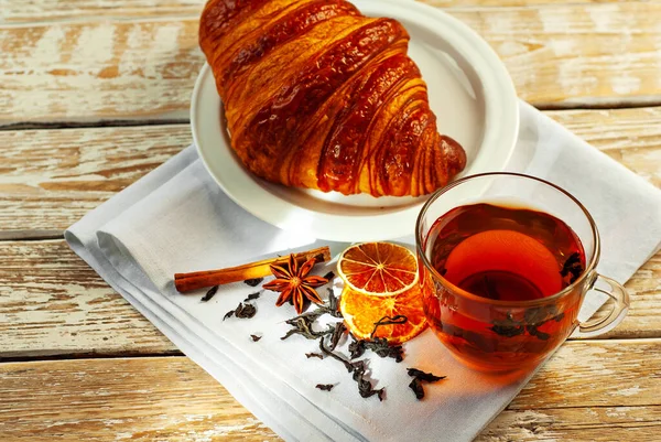 Croissant Einem Weißen Teller Mit Tee Becher Mit Tee Auf lizenzfreie Stockfotos