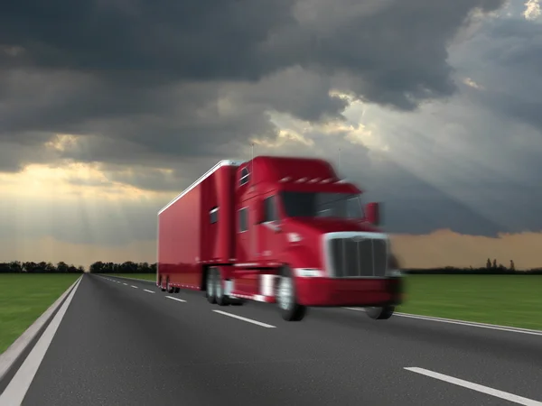 Red truck on blurry asphalt road over blue cloudy sky background — Stock Photo, Image