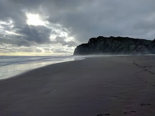 Karekare plajı, Batı Yakası, Auckland, Yeni Zelanda 'daki siyah bir kumsaldır..