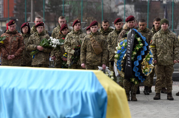 Lviv, Ukraine - March 9, 2022: Funerals of Ukrainian servicemen killed during Russia's invasion of Ukraine, at Lychakiv cemetery in city of Lviv. 