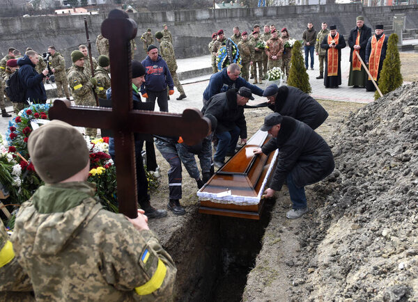 Lviv, Ukraine - March 9, 2022: Funerals of Ukrainian servicemen killed during Russia's invasion of Ukraine, at Lychakiv cemetery in city of Lviv. 