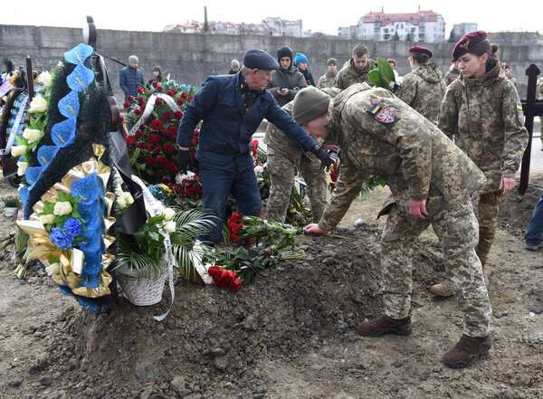 Lviv, Ukraine - March 9, 2022: Funerals of Ukrainian servicemen killed during Russia's invasion of Ukraine, at Lychakiv cemetery in city of Lviv. 