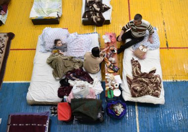 Lviv, Ukraine - March 10, 2022: Refugees rest in a gym of Lviv Polytechnic National University in the Western Ukraine. clipart