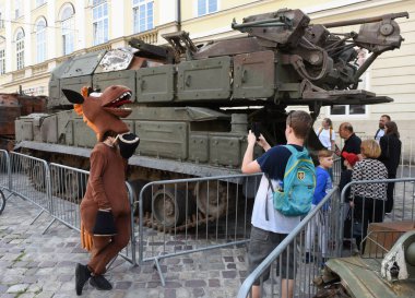 Lviv, Ukraine - August 11, 2022: People watch destroyed Russian military equipment that was destroyed in fights with the Ukrainian army, displayed as part of an outdoor exhibition in city of Lviv.