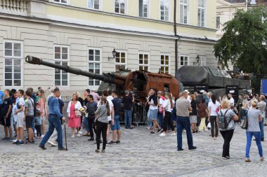 Lviv, Ukraine - August 11, 2022: People watch destroyed Russian military equipment that was destroyed in fights with the Ukrainian army, displayed as part of an outdoor exhibition in city of Lviv.