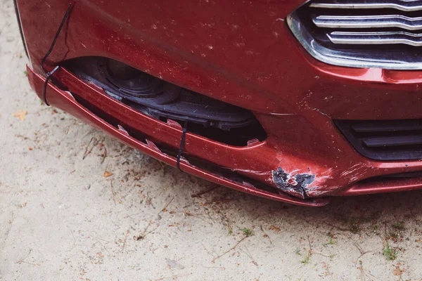 Dented front bumper. Self-repaired with yoke damaged red car. Off-road with low clearance. Uninsured vehicle.