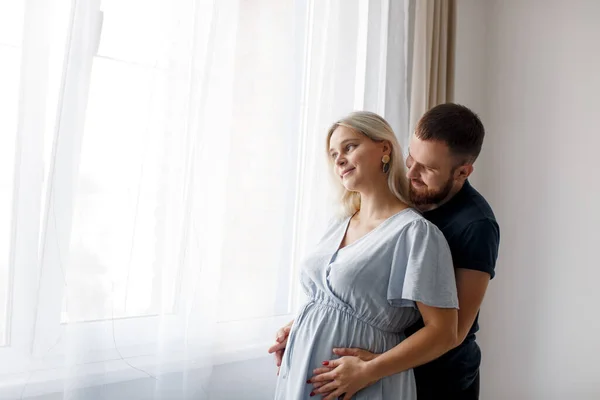 Man Hugs His Pregnant Wife Touches His Belly Window House — Fotografia de Stock