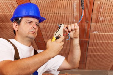 Worker installing electrical wiring