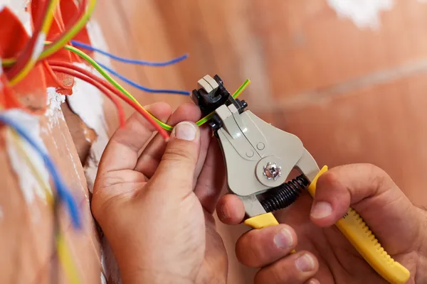 Elektriker zieht Drähte ab — Stockfoto