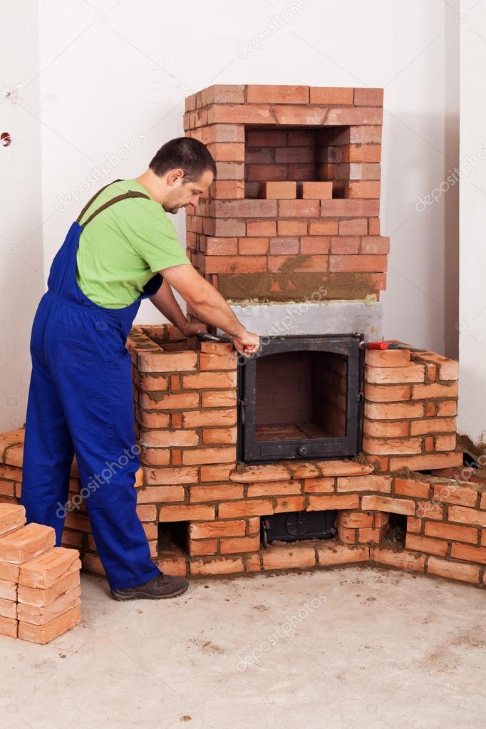 Worker mounting door to a masonry heater