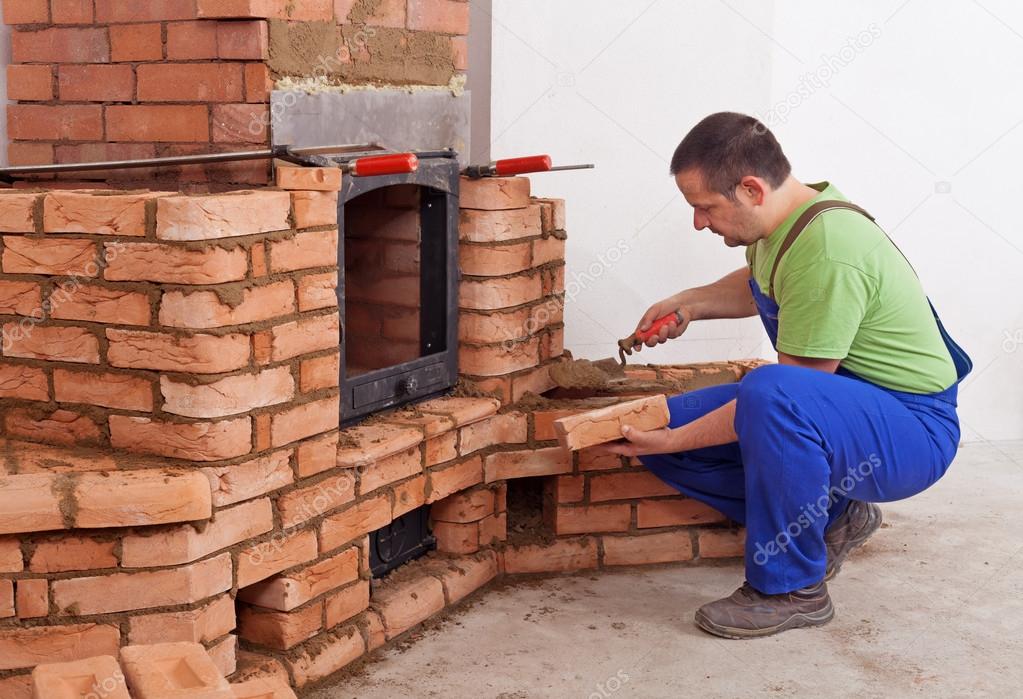 Worker building masonry heater