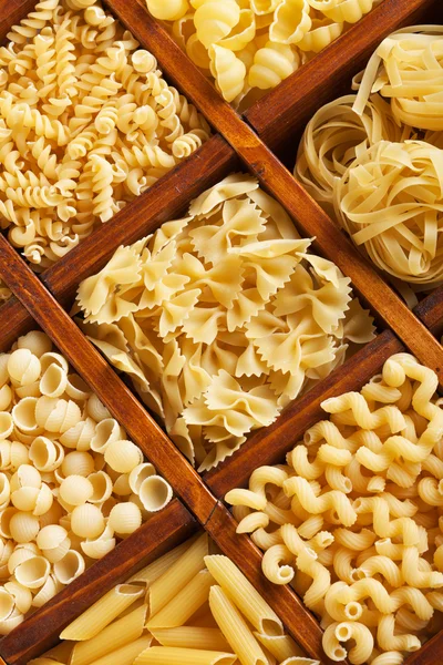 Pasta mix in compartmented wooden box — Stock Photo, Image