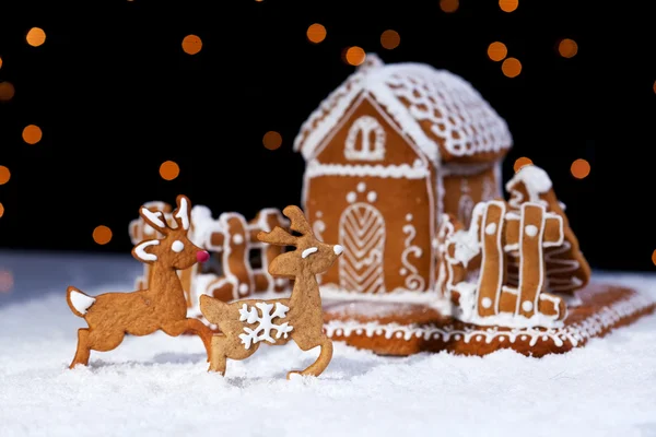 Christmas gingerbread cookie house and deers — Stock Photo, Image