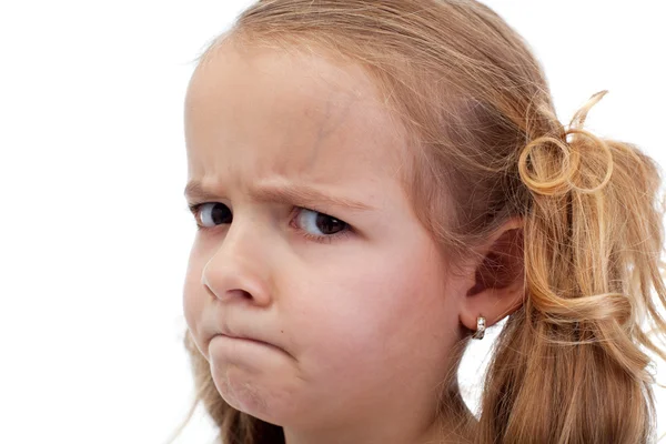 Doubtful little girl looking suspiciously — Stock Photo, Image