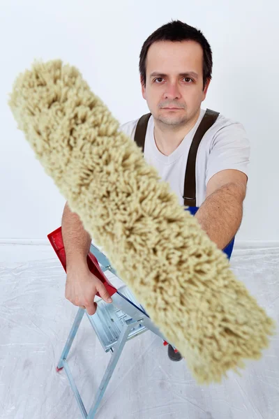Painter holding painting roller — Stock Photo, Image