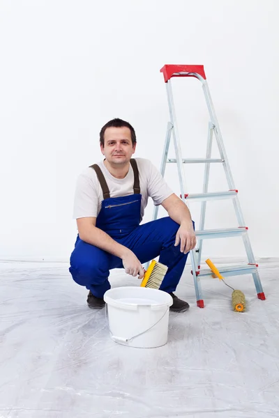 Worker with paint, brush and ladder — Stock Photo, Image