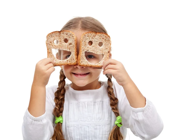 Happy little girl with plenty of food — Stock Photo, Image