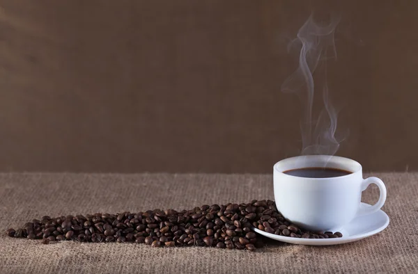 Cup of hot steaming coffee — Stock Photo, Image