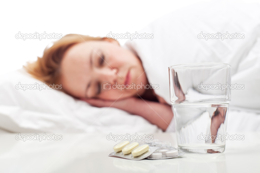 Woman fighting sickness with pills and resting