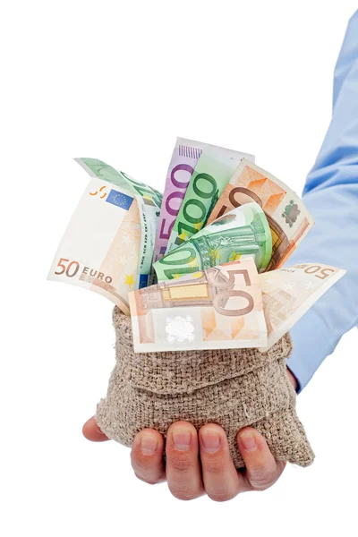 Businessman hand with a bag full of euro banknotes — Stock Photo, Image