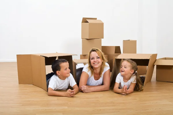 Happy woman and kids relaxing in their new home — Stock Photo, Image