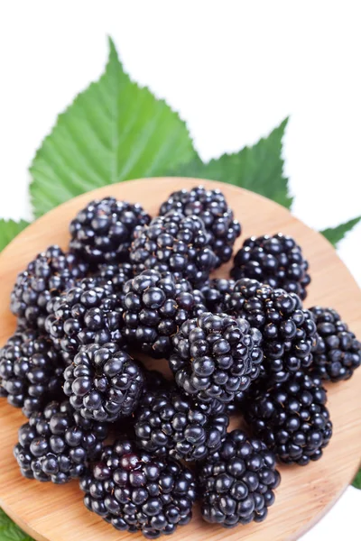 Blackberries on wooden plate — Stock Photo, Image