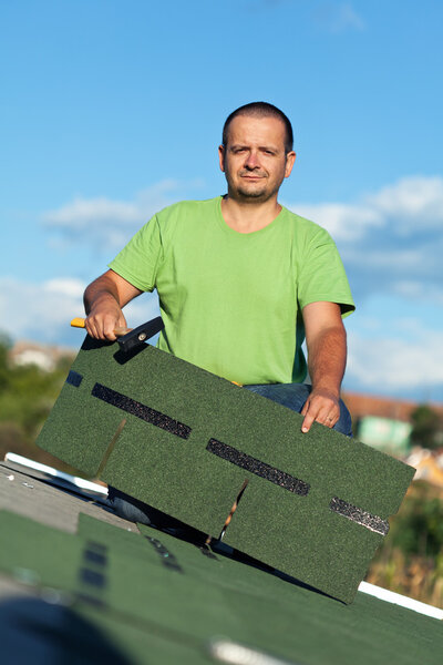 Roofer on top of building