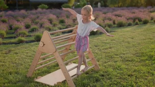 Blonde Girl Playground She Walks Her Arms Outstretched Girl Trying — Stock Video