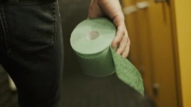 Umumi bir yerde bir adam tuvalete gider. Erkek, elinde tuvalet kâğıdı taşır. Kişi, lavabonun kapısını açıp kapatmış..