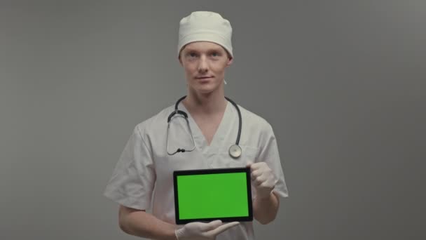 Young Doctor Medical Gown Gloves Holds Tablet Has Stethoscope His — Vídeo de Stock