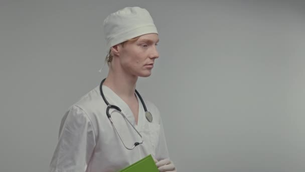 Young Doctor Medical Gown Gloves Has Stethoscope His Neck White — Vídeo de Stock