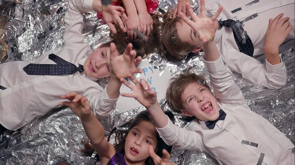 Five Children Lie Shiny Surface Celebration Having Fun Them Sheet — kuvapankkivalokuva