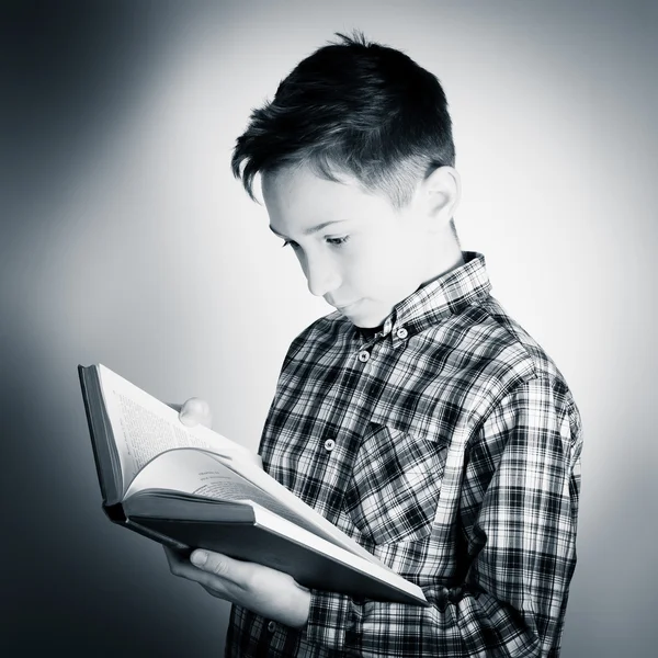 Schoolboy reading a book — Stock Photo, Image