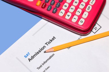 SAT admission test ticket with pencil and Calculator, concept of SAT eam taking.