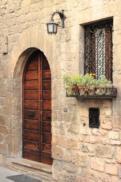 Medieval door with lamp and window — Stock Photo, Image