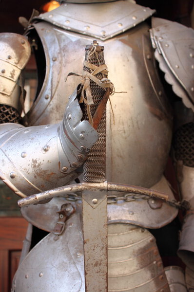 Iron gauntlet and sword of a medieval armor