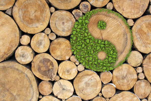 Stacked Logs Background with ying yang