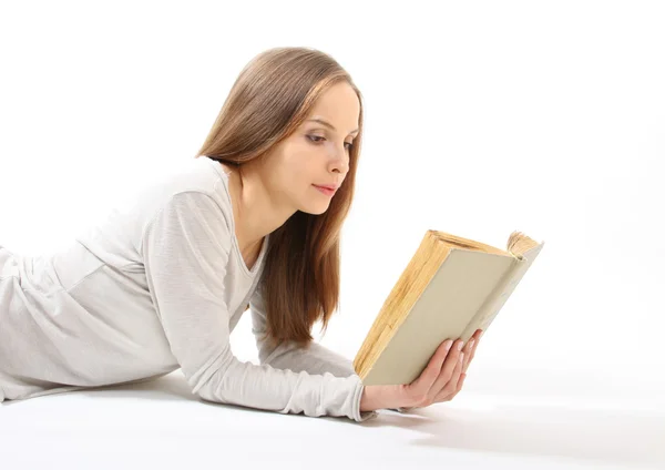 Chica mentirosa con un libro — Foto de Stock