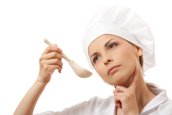 Beyaz izole kaşıkla yiyen kadın aşçı — Stok fotoğraf
