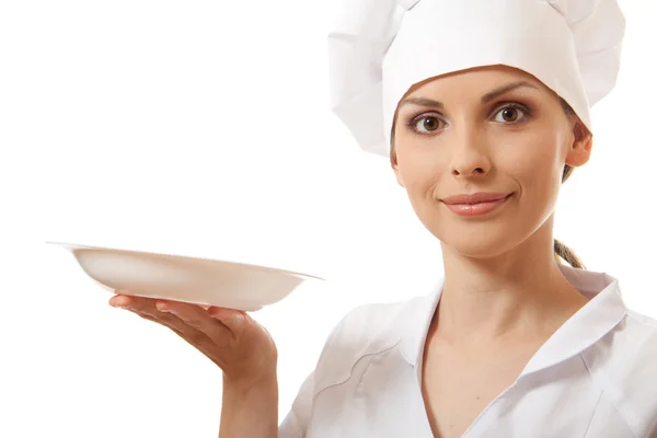 Mulher cozinheiro segurando prato vazio — Fotografia de Stock