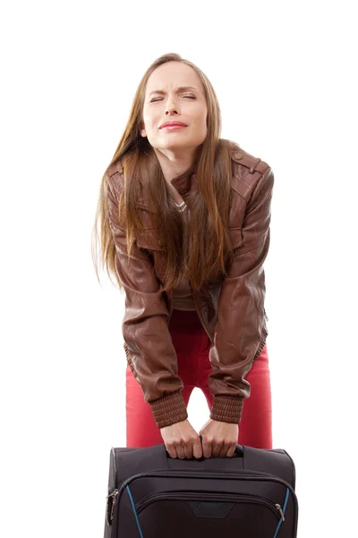 Woman lifts a heavy suitcase — Stock Photo, Image