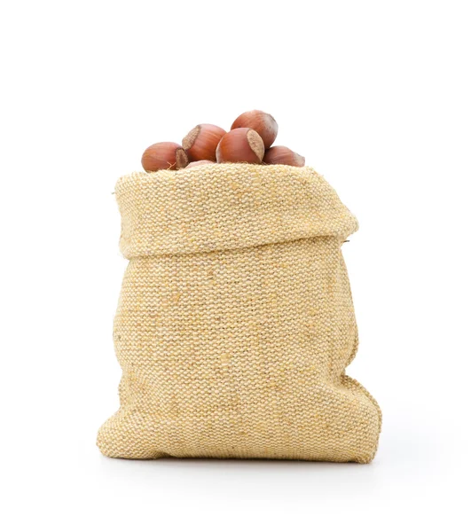 Hazelnuts in a burlap bag on white background — Stock Photo, Image