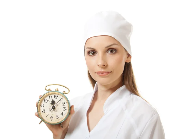 Vrouwelijke arts bedrijf alarm clock, geïsoleerd Stockfoto
