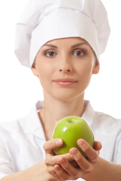 Lachende vrouw kok met groene appel — Stockfoto