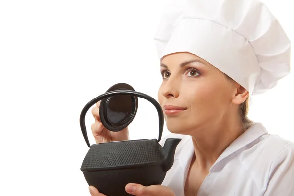 Female cook / chef in uniform with teapot — Stock Photo, Image