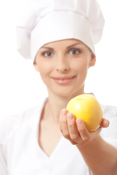 Smiling woman cook with yellow apple — Stock Photo, Image