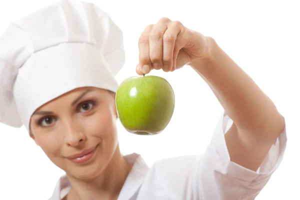 Χαμογελαστή γυναίκα μάγειρας με πράσινο μήλο — Φωτογραφία Αρχείου